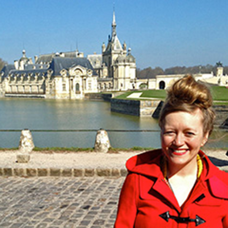 Kate Bastin outside the gate of the Château de Chantilly.