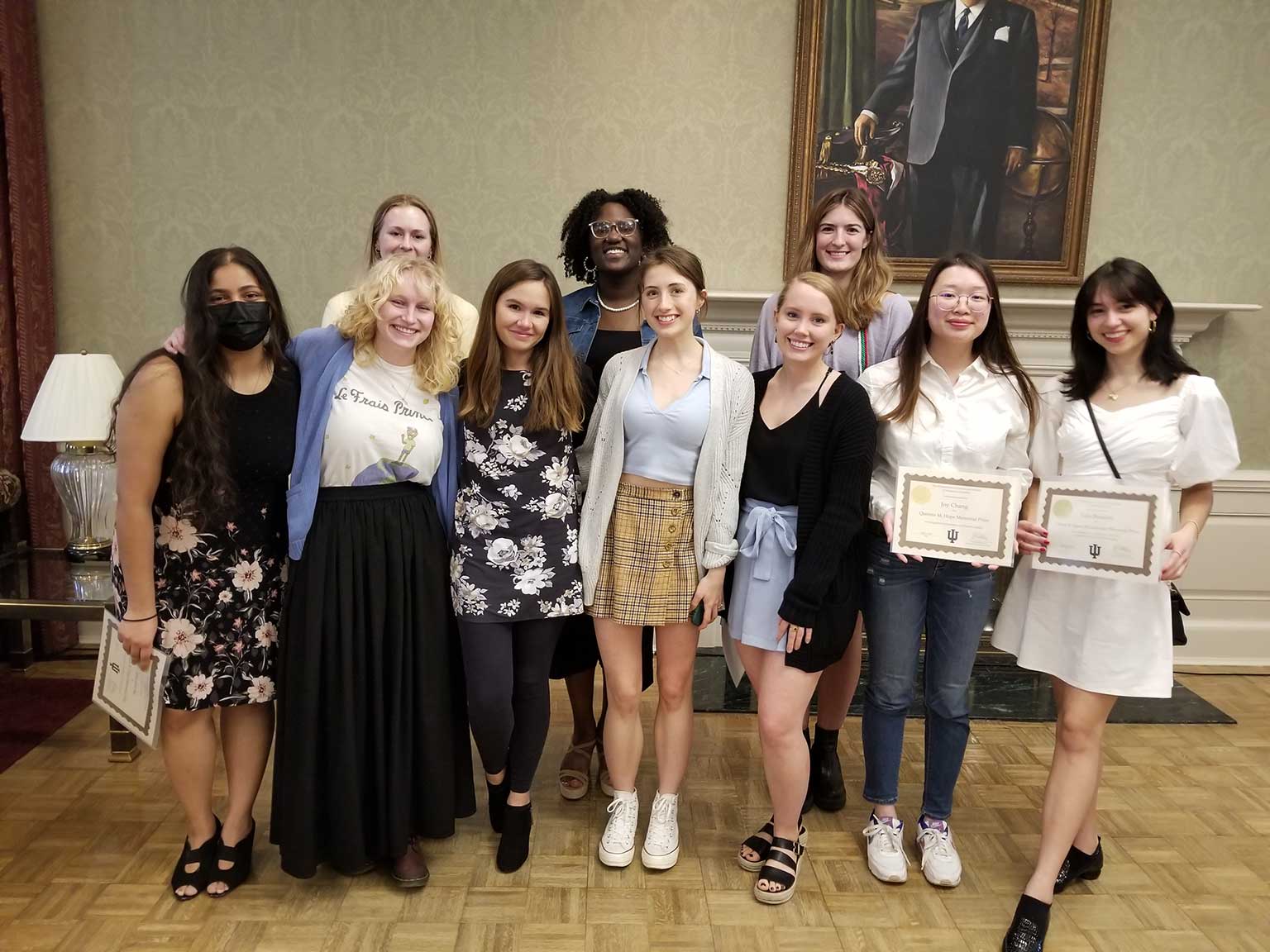 A group of undergraduate students pose with their recently earned award certificates.