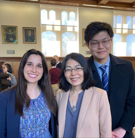 Three people pose together in Presidents Hall in Franklin Hall.