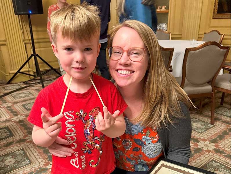 Professor Elizabeth Hebbard, the Trustees Teaching Award recipient, and her son”