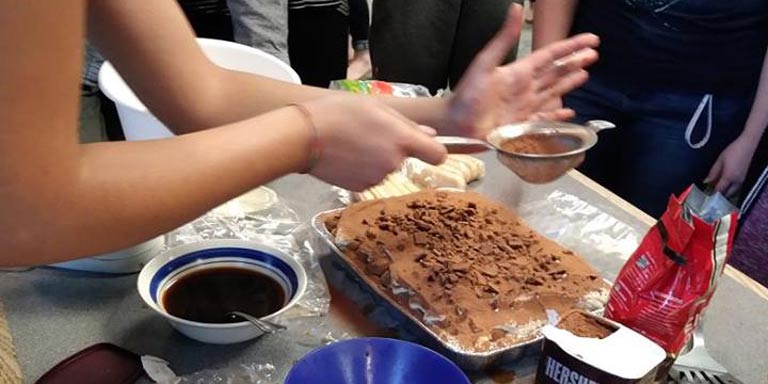 Italian students prepare dessert. 