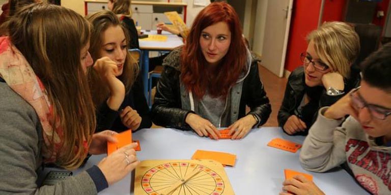 Students play a board game during French Club.